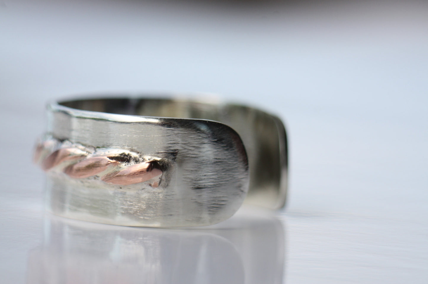 Adjustable silver ring with copper braid
