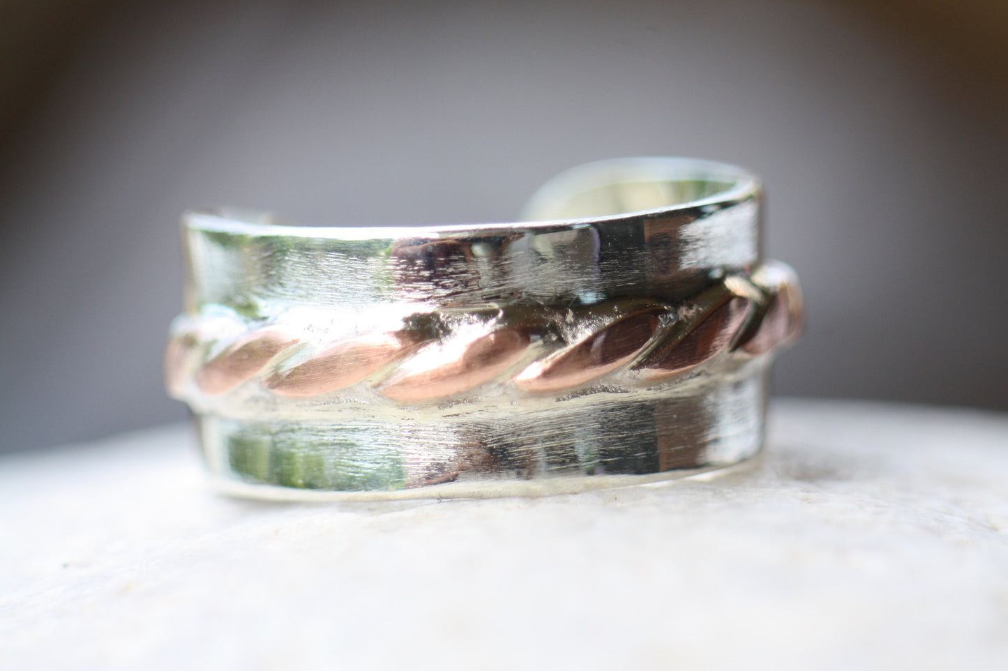 Adjustable silver ring with copper braid