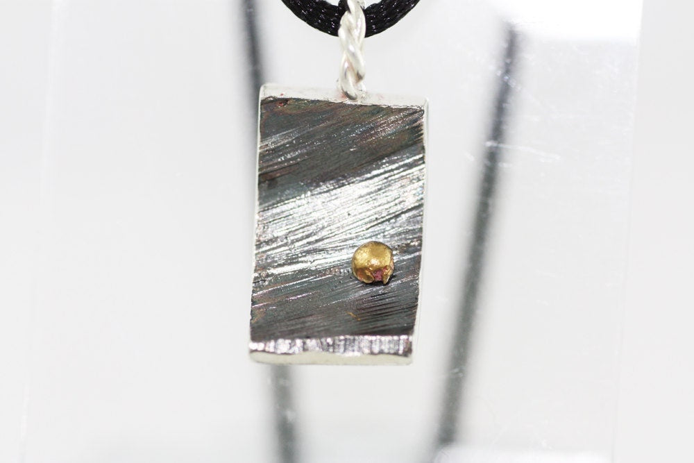 Silver pendant with gold details