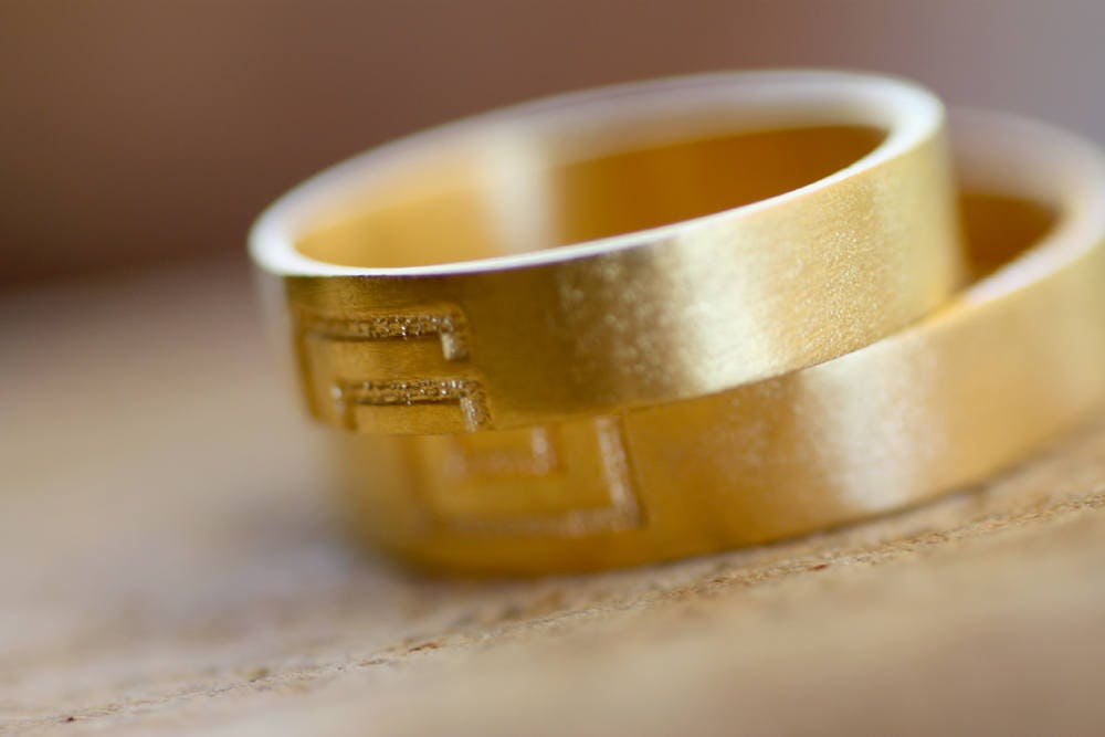 Meander sign Gold wedding bands for couples