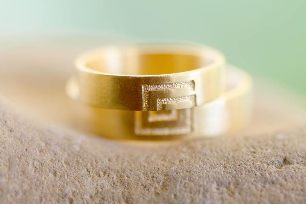 Meander sign Gold wedding bands for couples